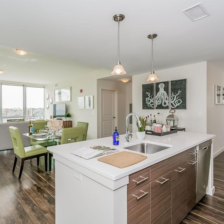 a kitchen and a dining room with a table and chairs