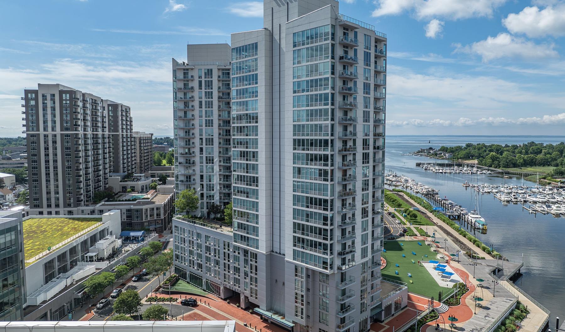 a tall building next to a river